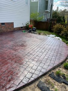 A brick patio with a red brick pattern.