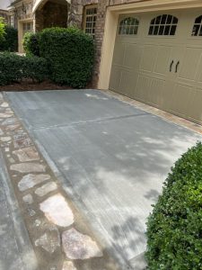 A driveway with stone and concrete in it